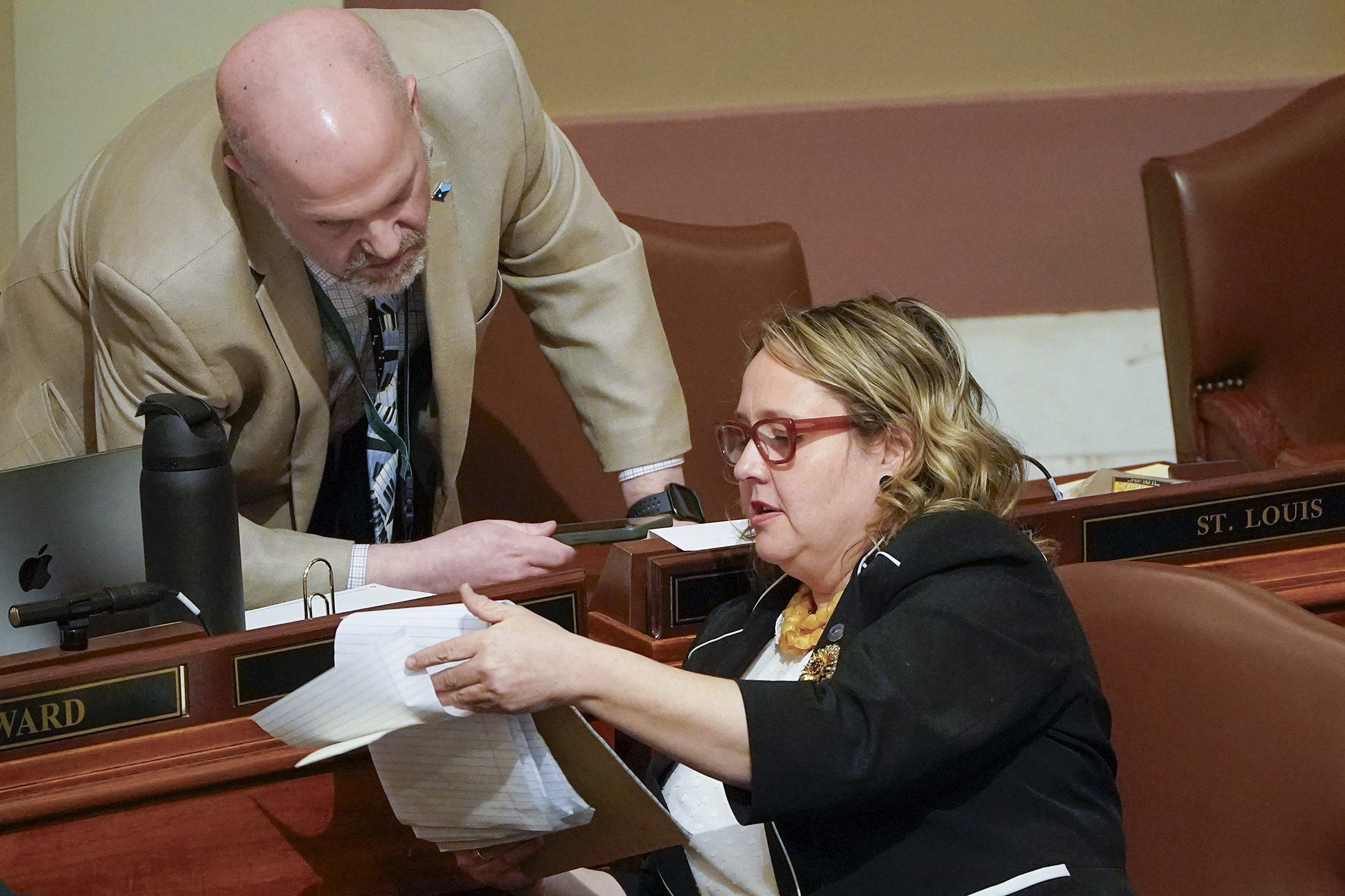 Rep. Mike Freiberg confers with Rep. Emma Greenman during debate Wednesday on HF4240/SF4006*. Sponsored by Freiberg, the elections administration bill was passed 119-15 and sent to the Senate. (Photo by Michele Jokinen)

